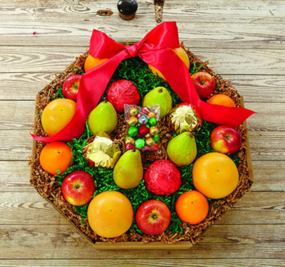 A wreath style box filled with Oranges, Grapefruit, apples and pears.